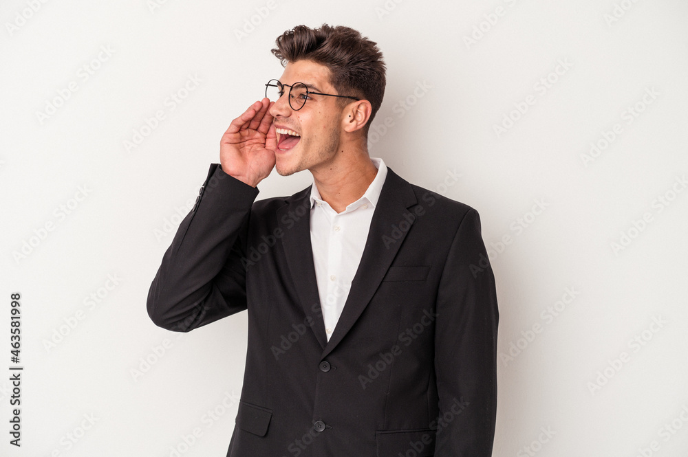 Young business caucasian man isolated on white background shouting and holding palm near opened mouth.