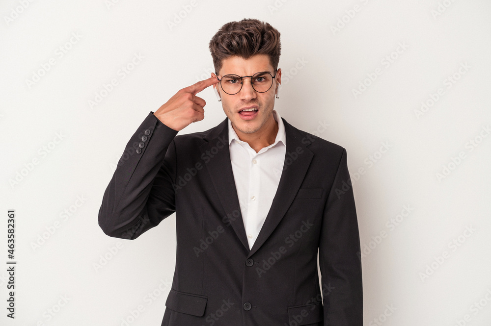 Young business caucasian man wearing headphones isolated on white background showing a disappointment gesture with forefinger. Young business caucasian man wearing headphones isolated on white background showing a disappointment gesture with forefinger.