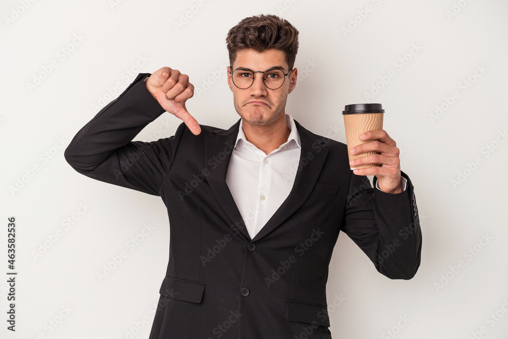Young business caucasian man holding take away coffee isolated on white background showing a dislike gesture, thumbs down. Disagreement concept. Young business caucasian man holding take away coffee isolated on white background showing a dislike gesture, thumbs down. Disagreement concept.