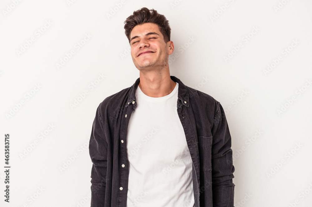 Young caucasian man isolated on white background laughs and closes eyes, feels relaxed and happy. Young caucasian man isolated on white background laughs and closes eyes, feels relaxed and happy.