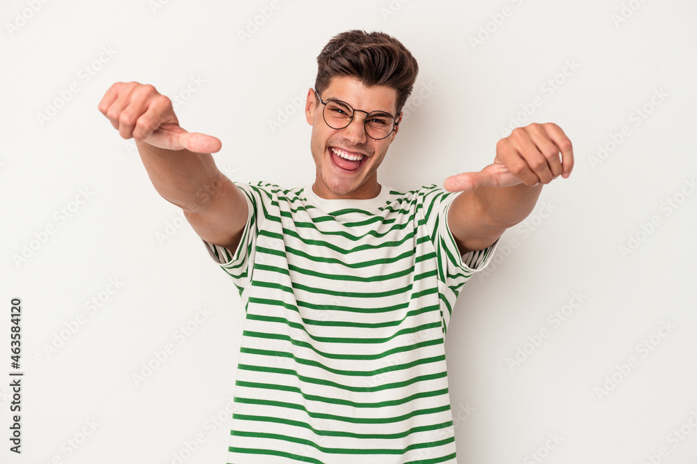 Fototapeta premium Young caucasian man isolated on white background raising both thumbs up, smiling and confident.