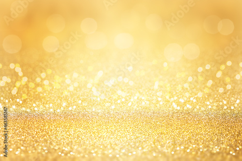 Golden glitter background. Abstract background with bokeh and defocused lights. Christmas holiday background