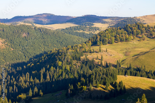 apuseni natural park of romania. landscape with forested rolling hills and valleys in evenign light. popular travel destination. beautiful nature scenery in early autumn photo