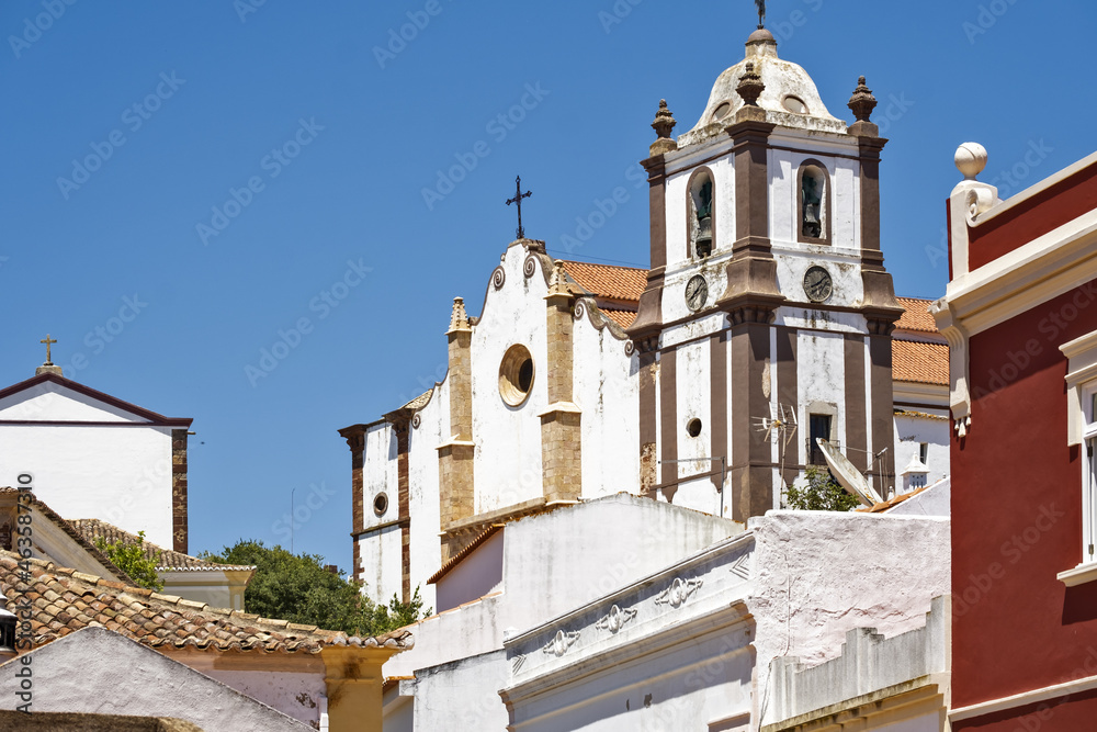 View over the town rooftops and houses towards the Gothic cathedral (Igreja da Misericordia) of Silves, algarve, Portugal