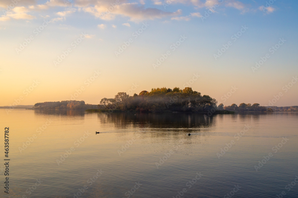 Beautiful island with fog at sunset. Summer landscape