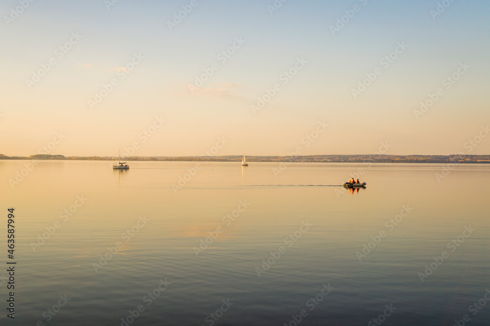 Beautiful water landscape with boat at sunset