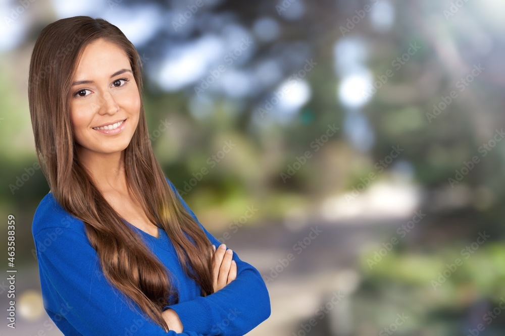 Happy young woman posing on outdoor background Happy young woman posing on outdoor background