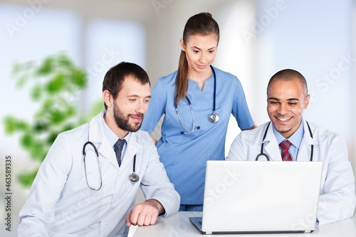 Doctor talking to an online patient on laptop screen sitting at clinic office  online consultation