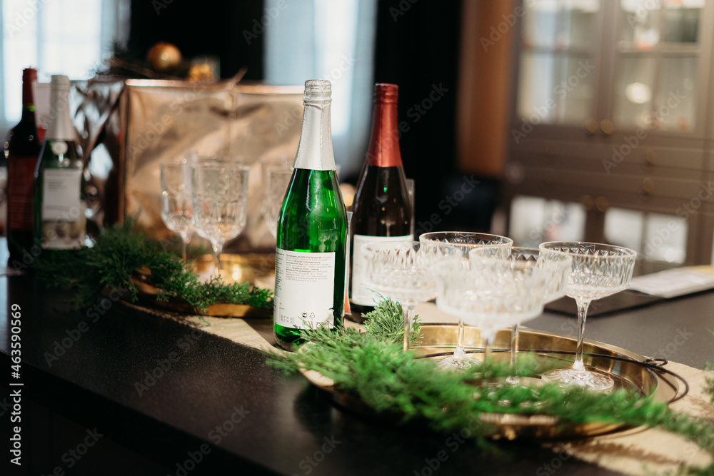 decoration of the New Year's table, champagne, wine, flowers, gifts