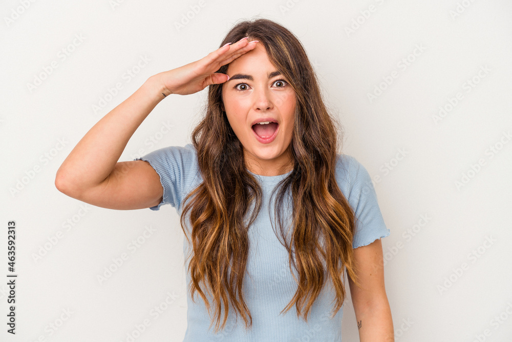 Young caucasian woman isolated on white background shouts loud, keeps eyes opened and hands tense. Young caucasian woman isolated on white background shouts loud, keeps eyes opened and hands tense.