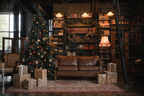 christmas home decoration in classic dark style with library, leather sofa, decorated Christmas tree