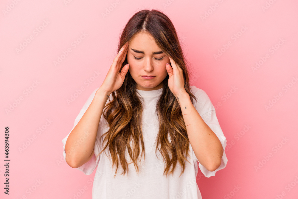 Young caucasian woman isolated on pink background touching temples and having headache. Young caucasian woman isolated on pink background touching temples and having headache.