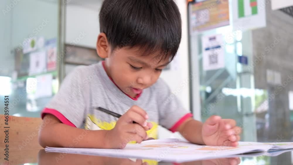 Asian little boy doing homework at home Asian little boy doing homework at home