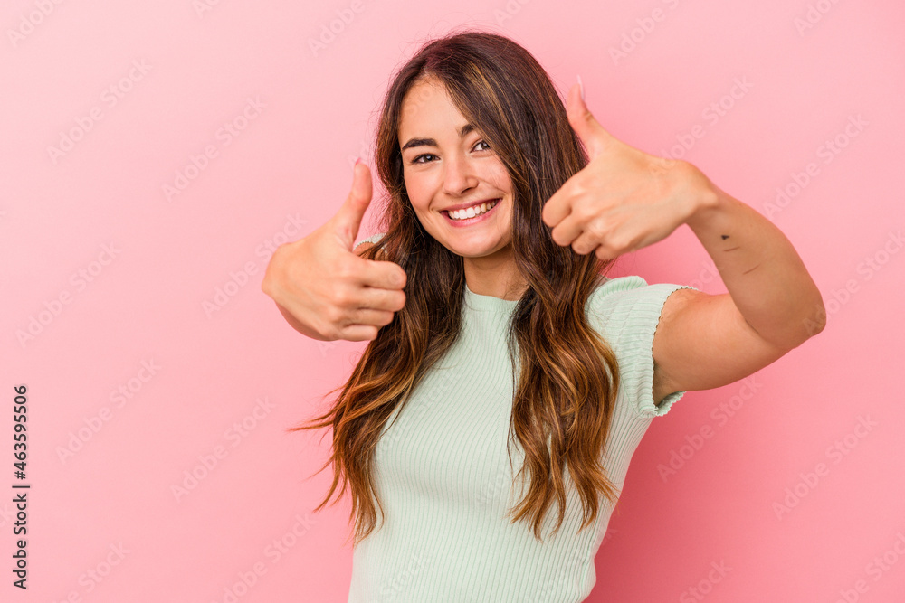 Young caucasian woman isolated on pink background raising both thumbs up, smiling and confident. Young caucasian woman isolated on pink background raising both thumbs up, smiling and confident.