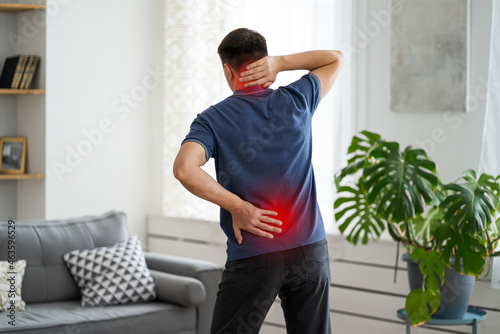 Back pain, man with backache at home