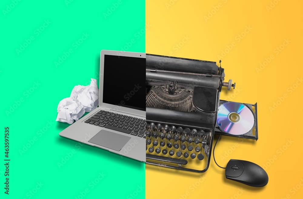 Old vs new technology. Modern computer and typewriter Stock Photo