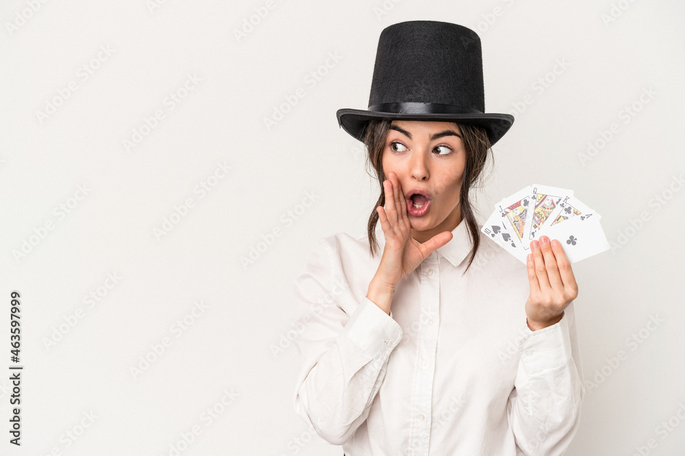Young magician woman holding a wand isolated on white background is saying a secret hot braking news and looking aside Young magician woman holding a wand isolated on white background is saying a secret hot braking news and looking aside