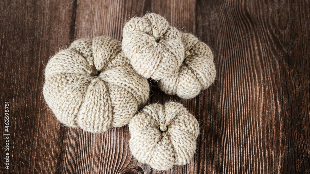 Hand made fabric pumpkin over grey knitted blanket for fall home decoration Hand made fabric pumpkin over grey knitted blanket for fall home decoration
