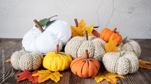 Hand made fabric pumpkin over grey knitted blanket for fall home decoration