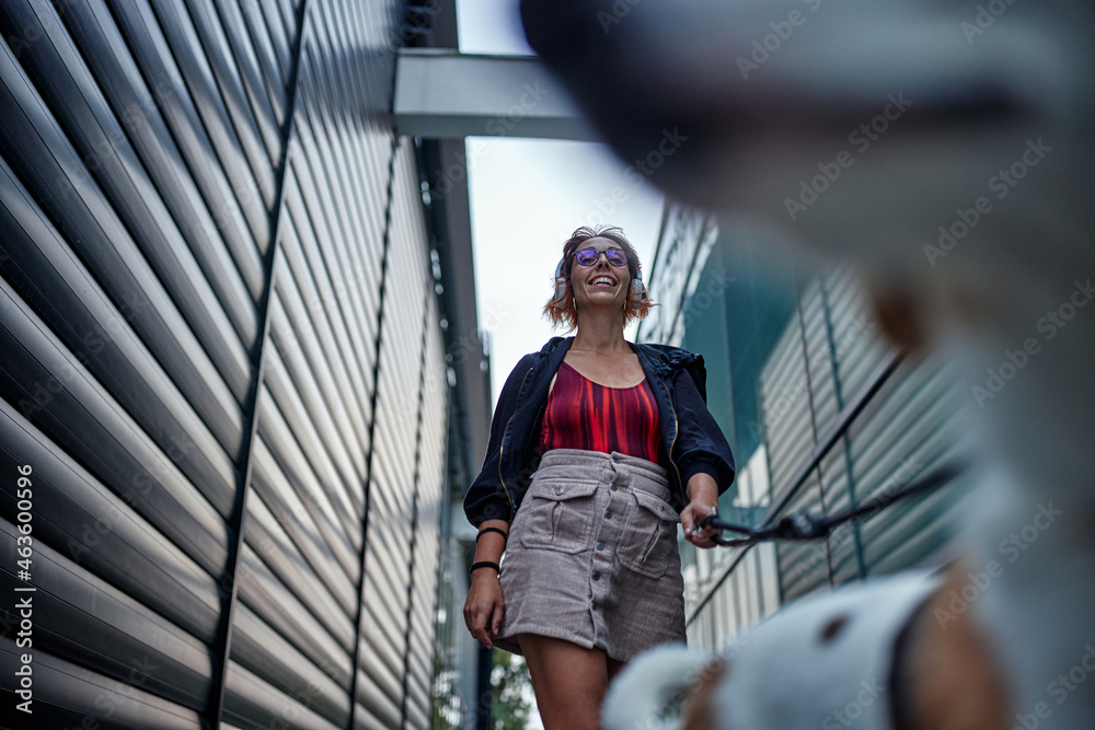 Young woman walking her dog outdoors