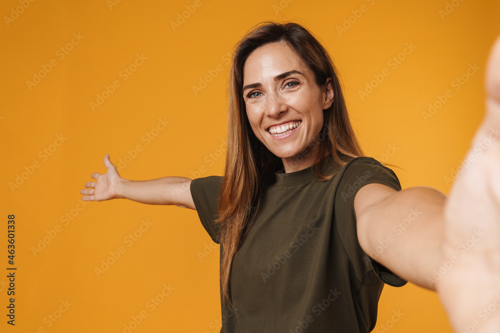 European ginger woman showing copyspace while taking selfie photo European ginger woman showing copyspace while taking selfie photo