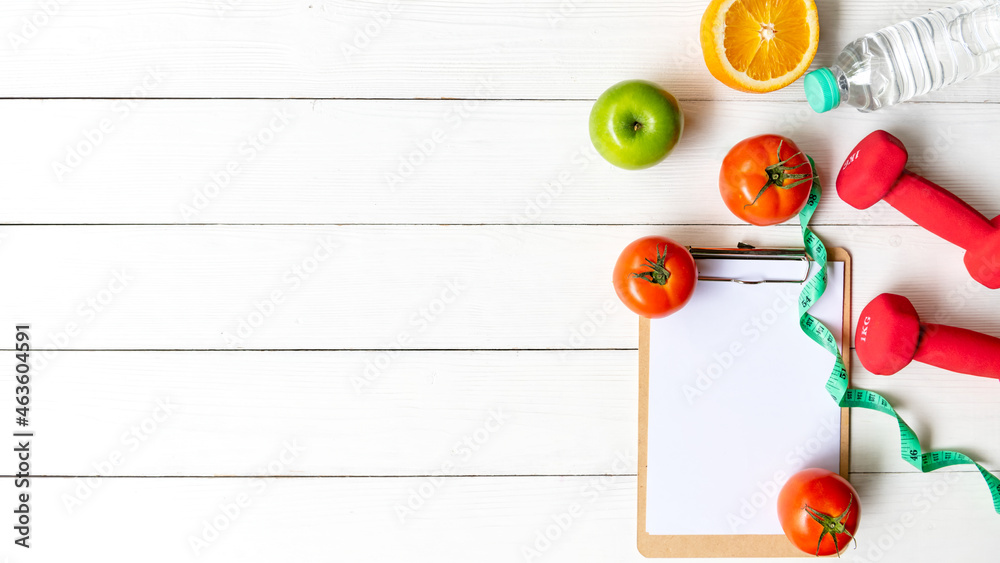 Planning for Diet Health eat and food. Sport exercise equipment workout with fresh fruit, measuring tape, note pad for fitness style. Nutrition Healthy Lifestyle Concept, Top view and copy space Planning for Diet Health eat and food. Sport exercise equipment workout with fresh fruit, measuring tape, note pad for fitness style. Nutrition Healthy Lifestyle Concept, Top view and copy space
