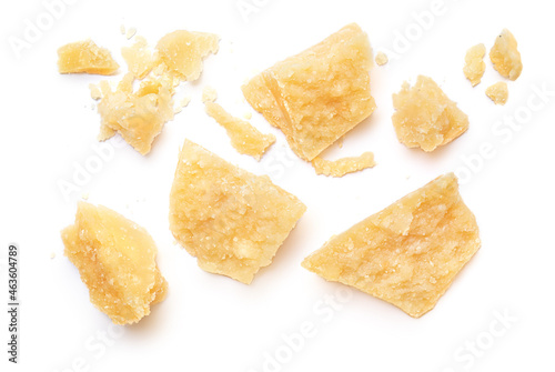 Pieces of parmesan cheese isolated on white background. Pattern. Parmesan crumbs top view. Flat lay.