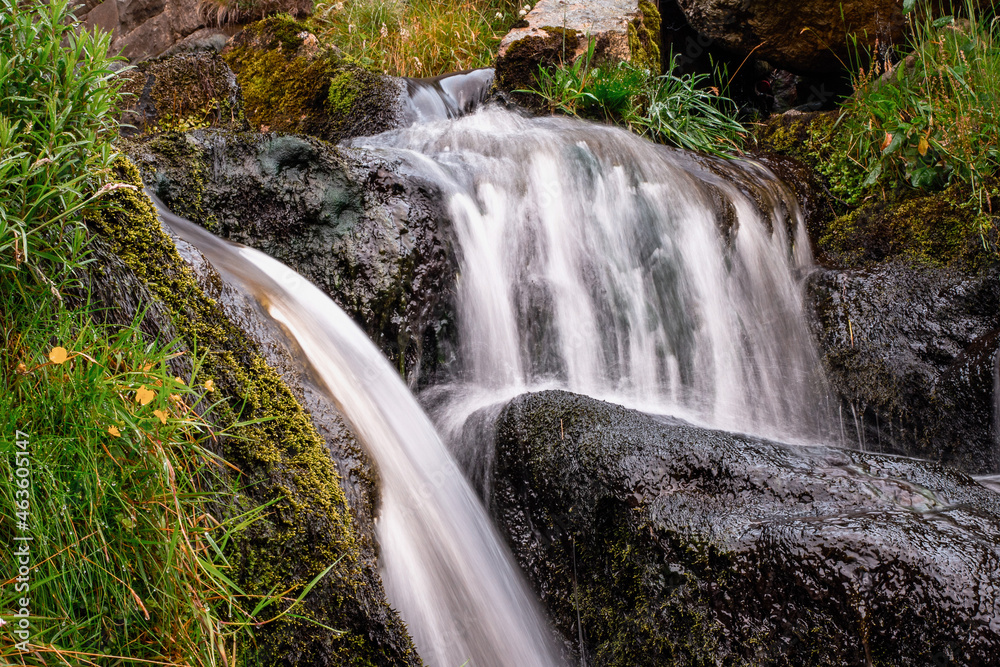 Small water wall and a pool of water. Beautiful nature landscape scene. Dark and moody tone.