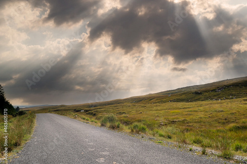 Small narrow country road in Connemara  county Galway  Ireland. Dramatic sky. Irish landscape. Beautiful nature scene