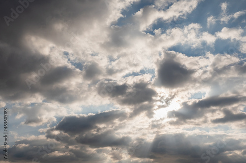 Spectacular cloudy sky with sun rays. Muted colors. Nature background