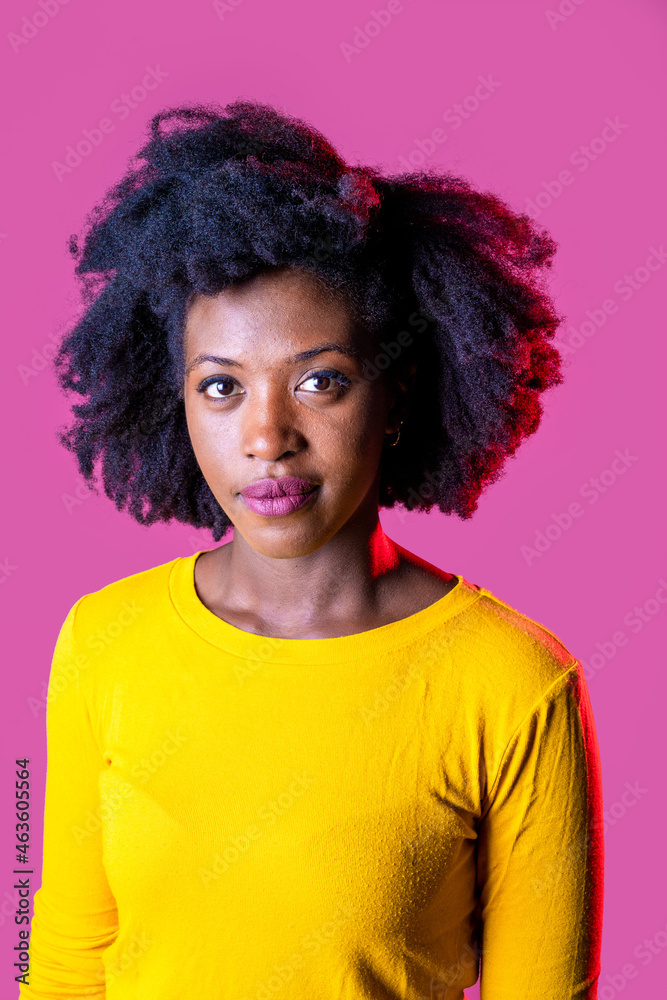 Studio portrait young black woman looking camera smiling positive and contemplative daydreaming isolated background Studio portrait young black woman looking camera smiling positive and contemplative daydreaming isolated background