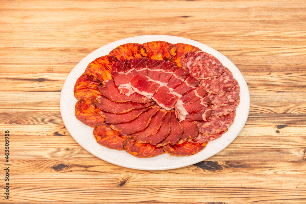 Spanish tapa of Iberian pork sausages with chorizo, salchichon, embuchado loin and Iberian ham Spanish tapa of Iberian pork sausages with chorizo, salchichon, embuchado loin and Iberian ham