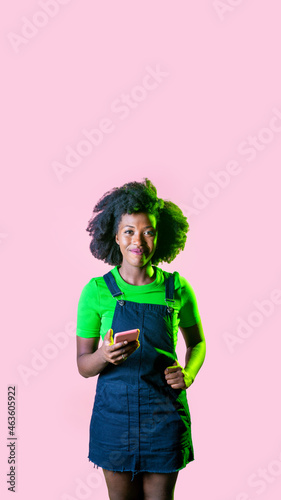 Young black woman using smartphone surfing internet trading crypto currency isolated background