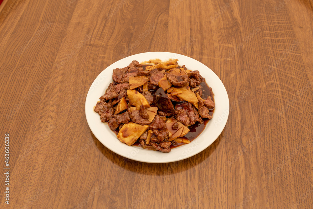 Chinese restaurant popular recipe with beef with bamboo and mushrooms, oyster and soy sauce on white plate Chinese restaurant popular recipe with beef with bamboo and mushrooms, oyster and soy sauce on white plate