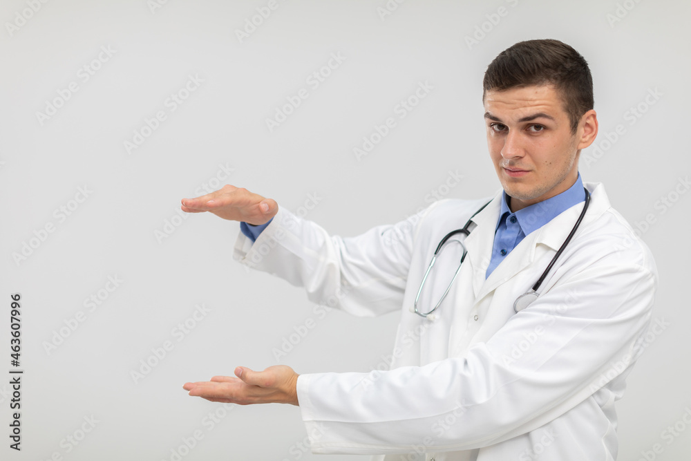 The doctor stands forward with a subdued expression and his hands raised. The doctor stands forward with a subdued expression and his hands raised.