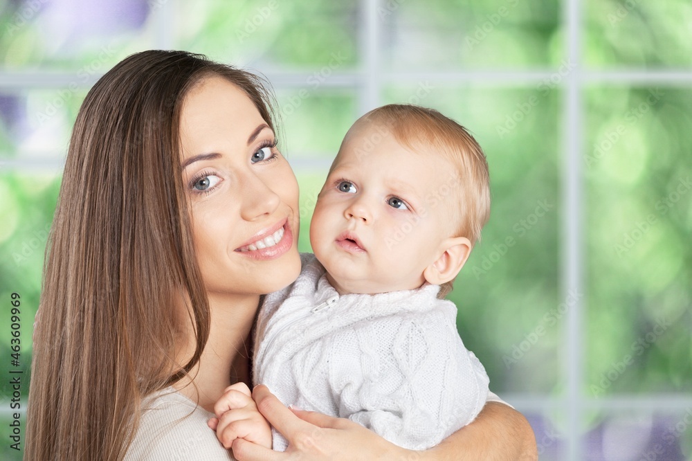 Young beautiful mother lifting and playing with her baby. Young beautiful mother lifting and playing with her baby.