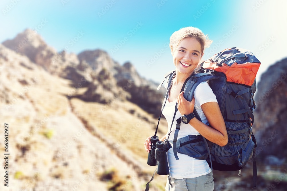 Young hiker hiking in mountain forest wearing backpack for camping outdoor. Young hiker hiking in mountain forest wearing backpack for camping outdoor.