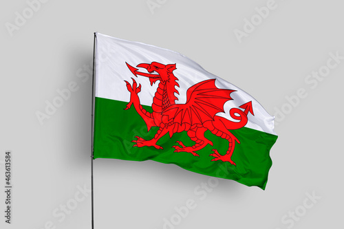 Wales flag isolated on the blue sky background. close up waving flag of Wales. flag symbols of Wales. Concept of Wales.