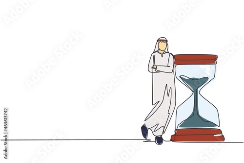 Continuous one line drawing Arab businessman lean on huge giant hourglass. Time is money financial investment concept. Time management conceptual metaphor. Single line draw design vector illustration