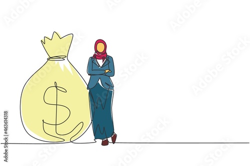 Single continuous line drawing Arabian businesswoman in hijab standing near big heavy bag with dollar sign. Female leaning on money sack. Successful concept. One line draw design vector illustration