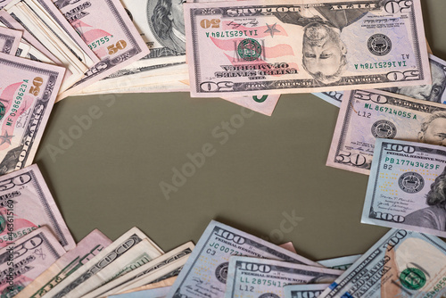 Frame from paper banknotes of dollars on olive color background. Banks and finance concept.