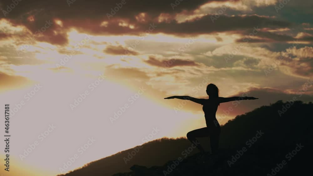 Woman practicing yoga on hillside at sunset, concept, freedom, health, peace
Woman practicing yoga on hillside at sunset, concept, freedom, health, peace