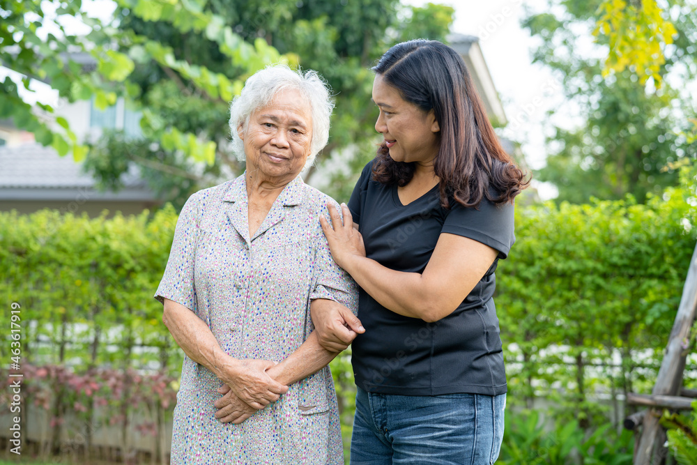 Asian elderly woman with caregiver daugther walking with happy in nature park. Asian elderly woman with caregiver daugther walking with happy in nature park.
