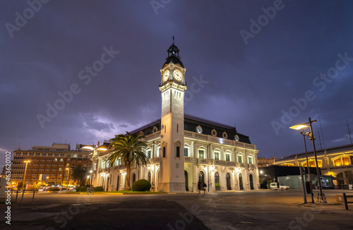 Port Authority building with clock tower in Valencia harbor, Spain night lights