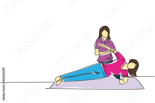 Single continuous line drawing woman patient lying on the floor masseur therapist doing healing treatment massaging patient body manual sport physical therapy. One line draw design vector illustration