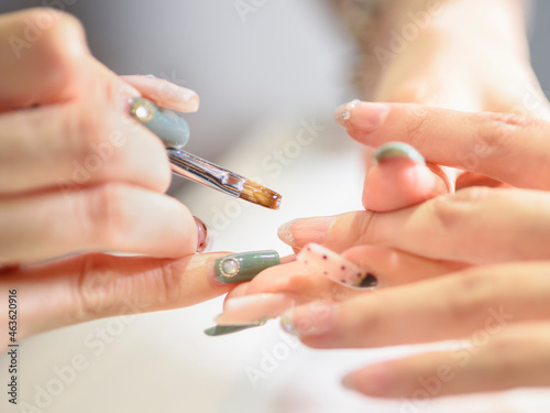 Manicurist polishing woman s nails