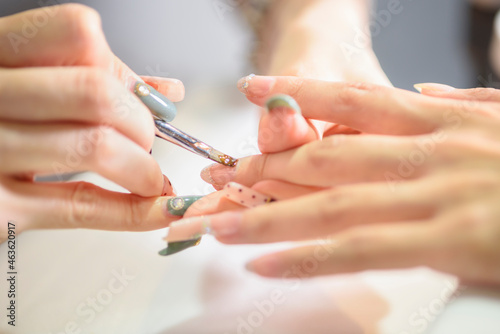 Manicurist polishing woman s nails