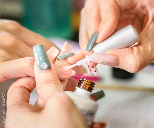 Manicurist polishing woman s nails