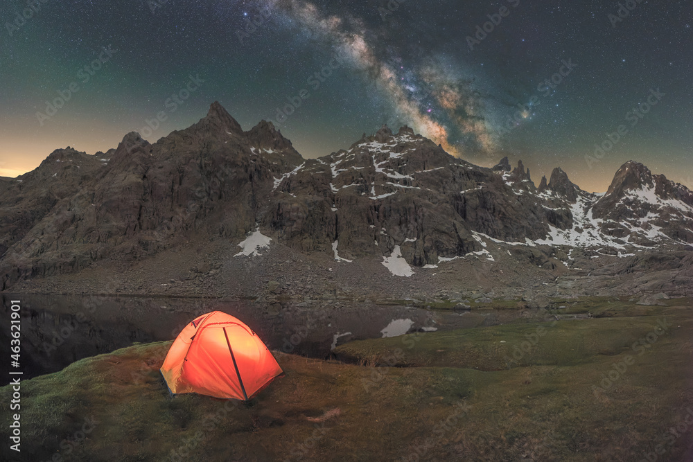 Tent in river against mount under starry sky Tent in river against mount under starry sky