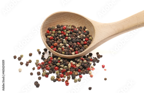 Colorful peppercorn mix, pepper pile in wooden spoon isolated on white background 